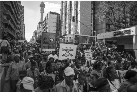 Picture of protesters in their thousands take to the streets of Johannesburg, holding up placards and denouncing xenophobia.
